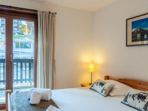 a hotel room with a bed and a window at Apartment Anemone 9 by Interhome in Nendaz