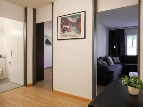 a living room with a mirror and a couch at Apartment Allod Park Haus C U04 by Interhome in Davos