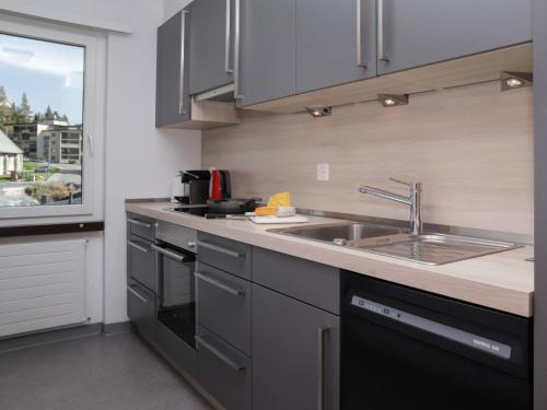 a kitchen with a sink and a counter top at Apartment Allod-Park-22 by Interhome in Davos