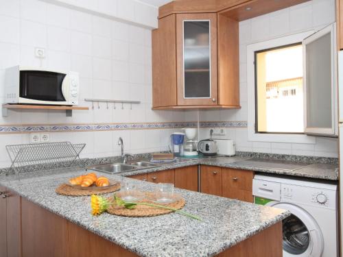 a kitchen with a counter with a bowl of fruit on it at Apartment El Junco by Interhome in Benidorm