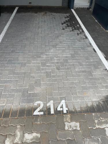 a brick sidewalk with the number on it at Apollo one bedroom in Sandton