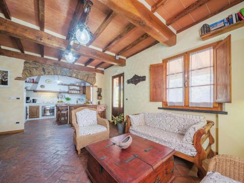 a living room with a couch and a table at Holiday Home L'Aia by Interhome in Seravezza