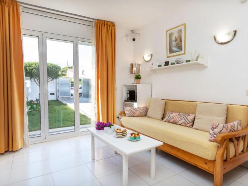 a living room with a couch and a table at Holiday Home Montalt I by Interhome in Miami Platja