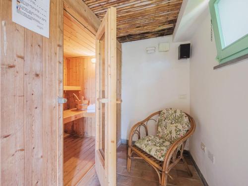 a hallway with a chair in a room with wooden walls at Holiday Home L'Aia by Interhome in Seravezza