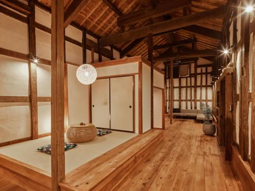 a large room with wooden floors and wooden beams at NIPPONIA Sawara Merchant Town Hotel in Katori