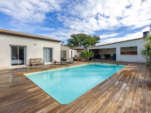 une piscine avec une terrasse en bois et une maison dans l'établissement Holiday Home Côté Sud - BZS165 by Interhome, à Corneilhan