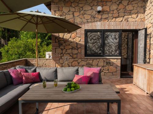 a patio with a couch and a table and an umbrella at Villa Villa Valentina by Interhome in Pisciarelli