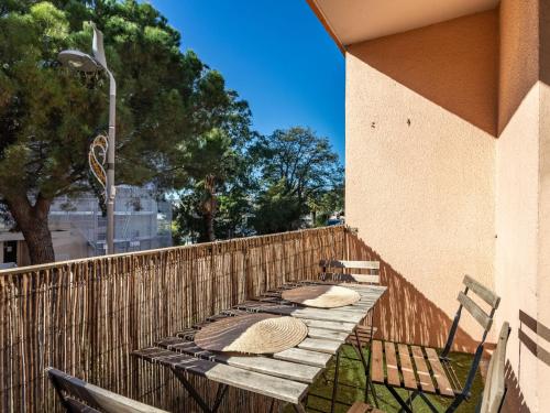 a row of tables on the side of a fence at Apartment Hélios by Interhome in Le Lavandou