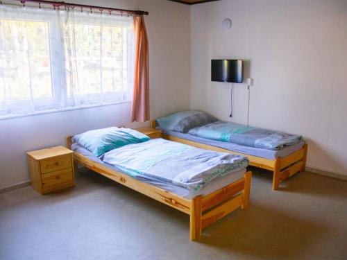 2 camas individuales en una habitación con ventana en Holiday Home Kemp Stříbrný rybník-1 by Interhome en Hradec Králové