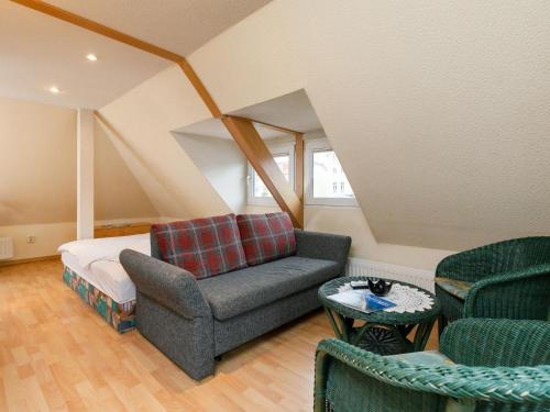 a living room with a couch and a bed at Apartment Melchien 2 by Interhome in Zinnowitz