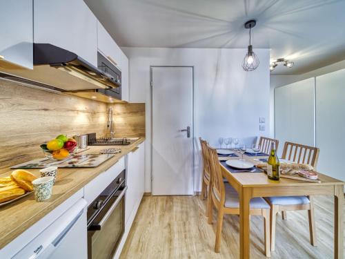 a kitchen with a table and a dining room at Apartment Altineige-6 by Interhome in Val Thorens