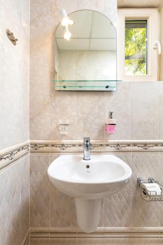 a bathroom with a sink and a mirror at Blacksmith's House - Old Town in Plovdiv