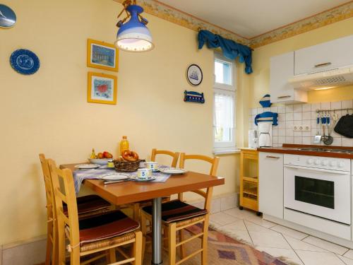 a kitchen with a table and chairs in a room at Apartment Melchien 1 by Interhome in Zinnowitz