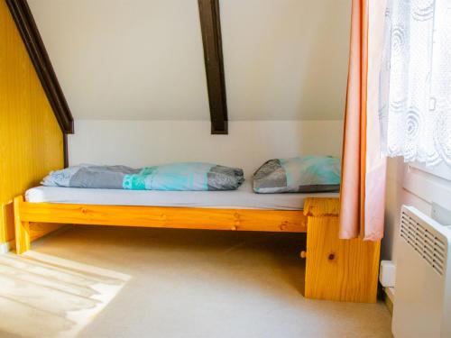 a bed with two pillows on it in a room at Holiday Home Kemp Stříbrný rybník-14 by Interhome in Hradec Králové