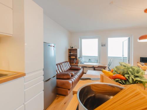 a kitchen and living room with a couch and a table at Apartment Unser Glück in den Bergen by Interhome in Bad Gastein