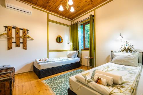 a bedroom with two beds and a couch at Blacksmith's House - Old Town in Plovdiv