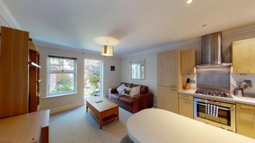 a kitchen and living room with a couch and a table at Elizabeth Jennings Way in Oxford
