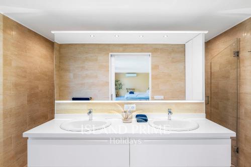 a bathroom with two sinks and a mirror at Private Villa in Golf del Sur in San Miguel de Abona