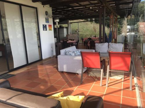 a living room with two chairs and a table at Refugio El Cacique in Guatavita