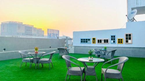 a patio with tables and chairs on a roof at BluO Studio1 DLF CyberCity - Balcony, Gym TT, Lift in Gurgaon