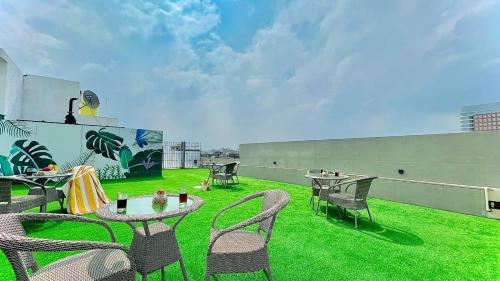 an outdoor patio with tables and chairs on a roof at BluO Studio1 DLF CyberCity - Balcony, Gym TT, Lift in Gurgaon