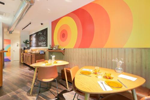 a restaurant with two tables and a large painting on the wall at Blume Cruz Suites in Madrid
