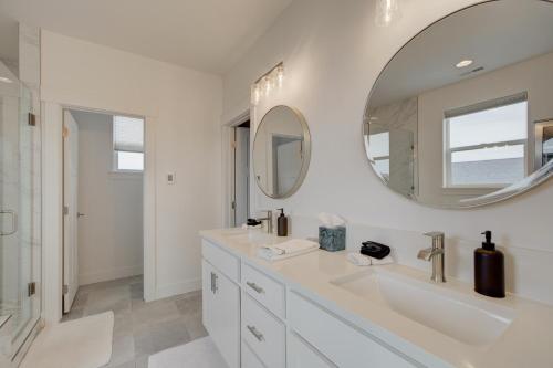 a white bathroom with a sink and a mirror at Yellowstone Country Outdoor Adventures, Sleeps 6 in Belgrade