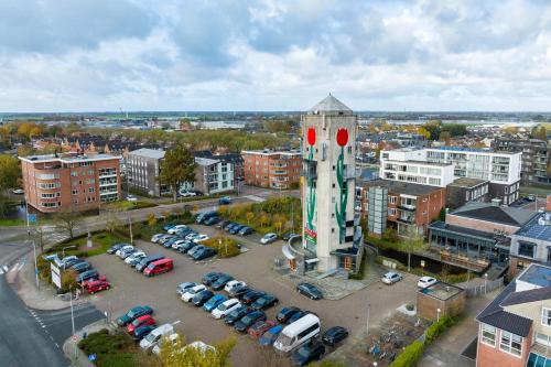 ein Parkplatz mit Uhrturm in einer Stadt in der Unterkunft B&B De Tulpentoren in Roelofarendsveen
