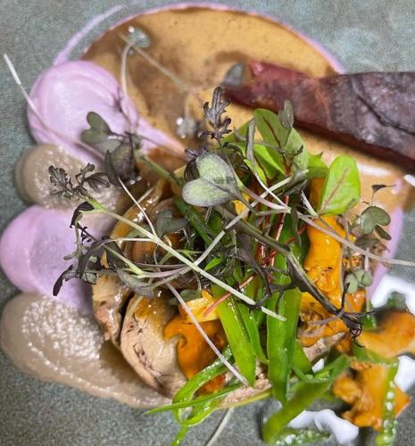 a plate of food with vegetables on a table at Logis des Sittelles in Montfort-le-Gesnois