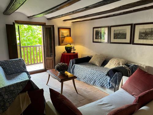 a living room with a couch and a table at La Casa del Bosque in Cabra de Mora