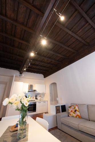 a living room with a vase of flowers on a table at La Casa del Palio in Ronciglione