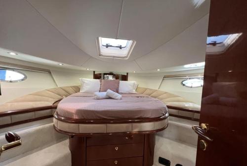 a bed in the middle of a boat at Bliss Motor yacht Fairline Squadron 52 in Piraeus