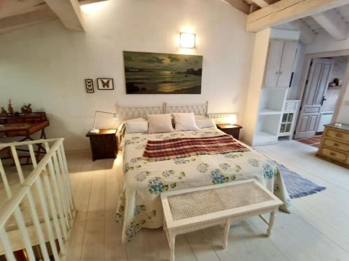 a bedroom with a large bed and a table at Casita de ensueño, en la sierra de Segovia in Segovia