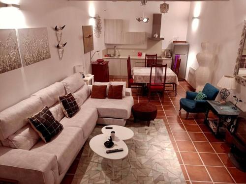 a living room with a couch and a table at Casita de ensueño, en la sierra de Segovia in Segovia