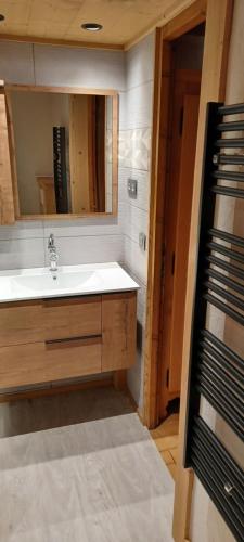 a bathroom with a sink and a mirror at les fenêtres du mont blanc in La Giettaz