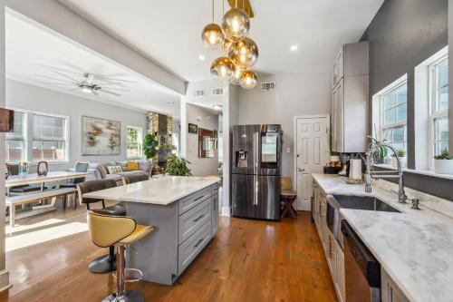 a kitchen with stainless steel appliances and a living room at GrandCraftsman style home with pool and hot tub/ center to all of New Orleans in New Orleans