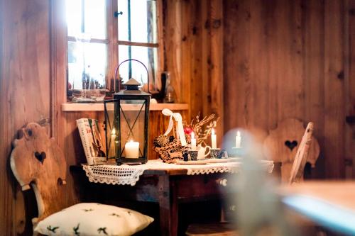 a room with a table with two chairs and a window at Hotel Tann in Collalbo