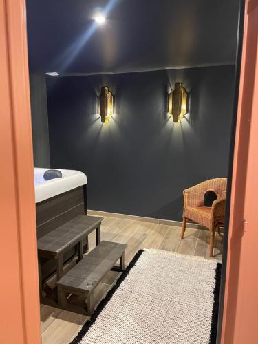 a bathroom with a sink and two lights on a wall at La Maison Gervaiserie & Spa in Réville