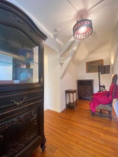 an empty living room with a large dresser and a table at Au Temps Des Chevaliers in Pau