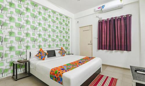 a bedroom with a large bed in a room at FabExpress Ashiyana Inn in Patna