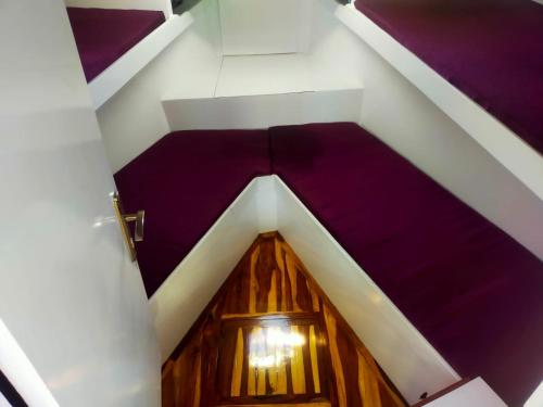an attic room with a purple floor and a wooden door at tiger in Hurghada