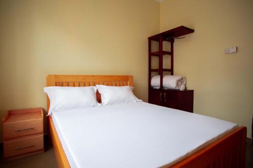 En eller flere senge i et værelse på BCB Homes