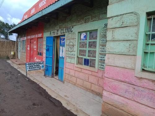 a building with colorful doors on the side of it at BARAKA HOUSE in Baruti West