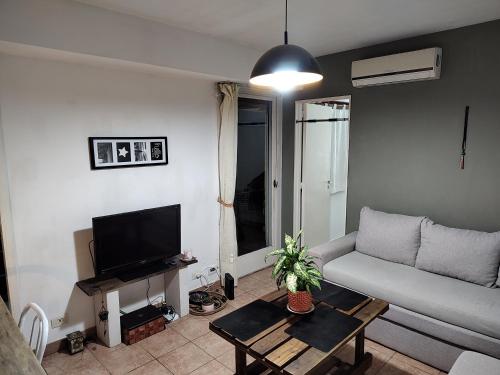 a living room with a couch and a tv at SANFER CENTER 2 in San Fernando