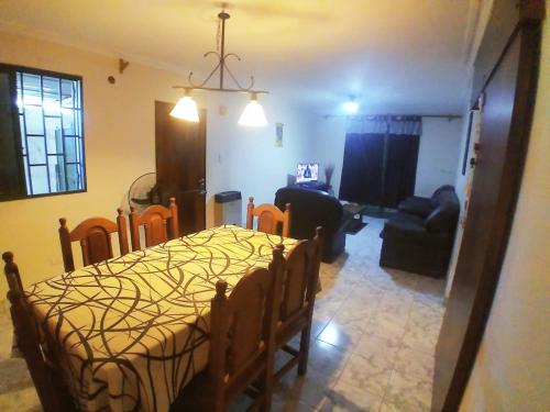 a room with a bed and a living room at La Casa Blanca in Salta