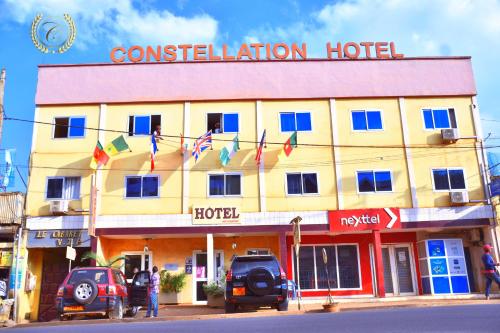 a hotel with flags in front of a building at CONSTELLATION HOTEL in Dschang