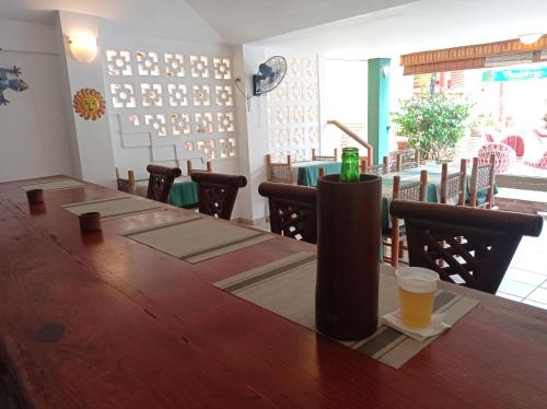 a table in a restaurant with a drink on it at Hotel Casa Coco in Boca Chica