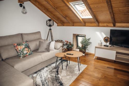 a living room with a couch and a table at Casa da Fidalguinha in Ponte de Lima