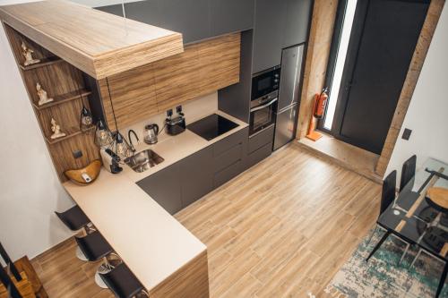 a small kitchen with a counter and wooden floor at Casa da Fidalguinha in Ponte de Lima