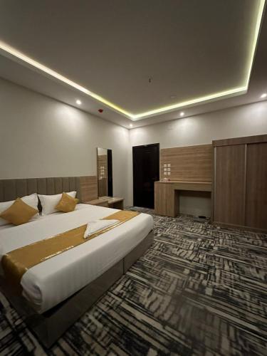 ein großes Schlafzimmer mit einem großen Bett und einem Kamin in der Unterkunft عليل الريف للشقق المخدومة in Al Bahah